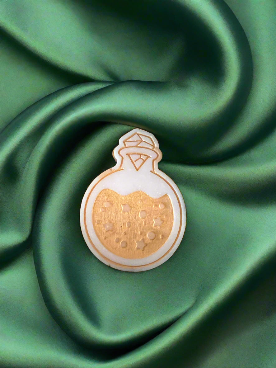 Moon Water wax melt on a dark green satin fabric