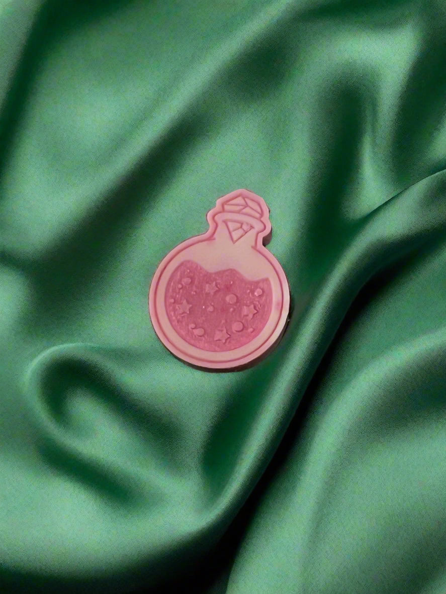 Moon Water wax melt on a dark green satin fabric
