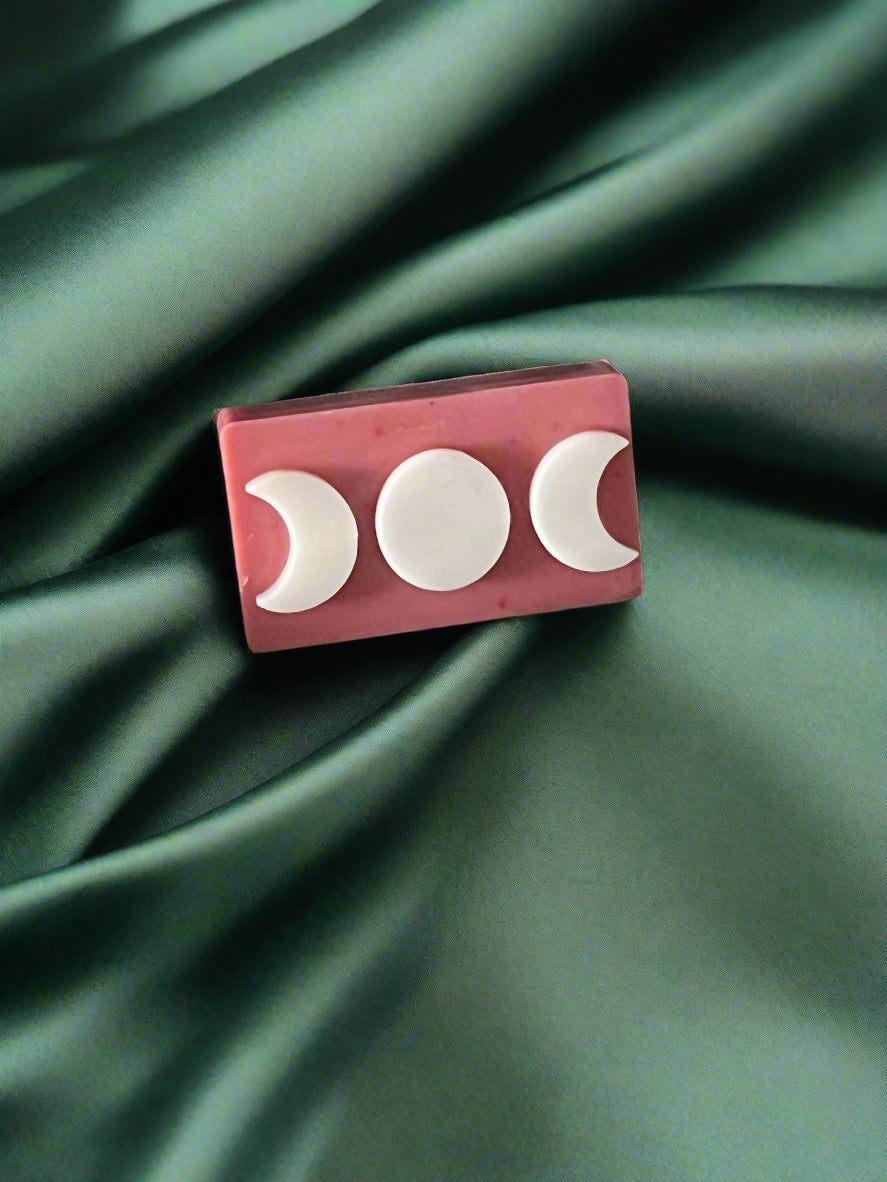 Triple moon wax melt on a green cloth