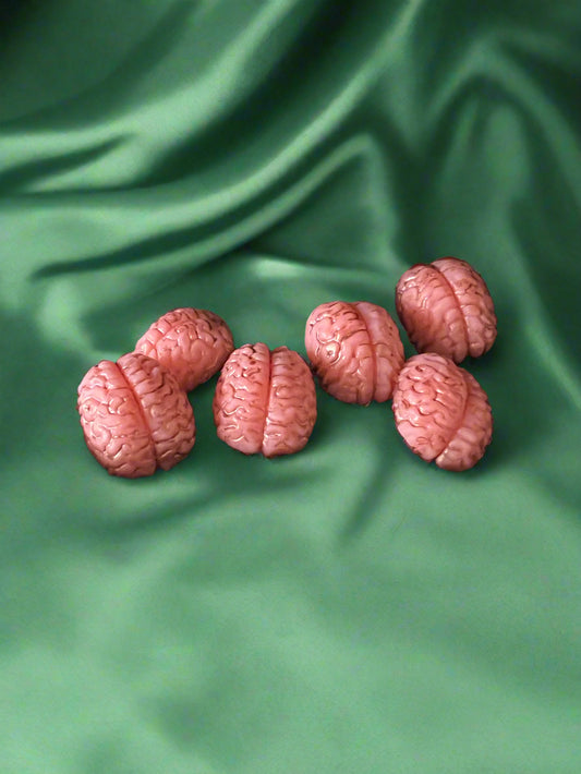 Six brain-shaped wax melts in pink color, displayed on a dark background.