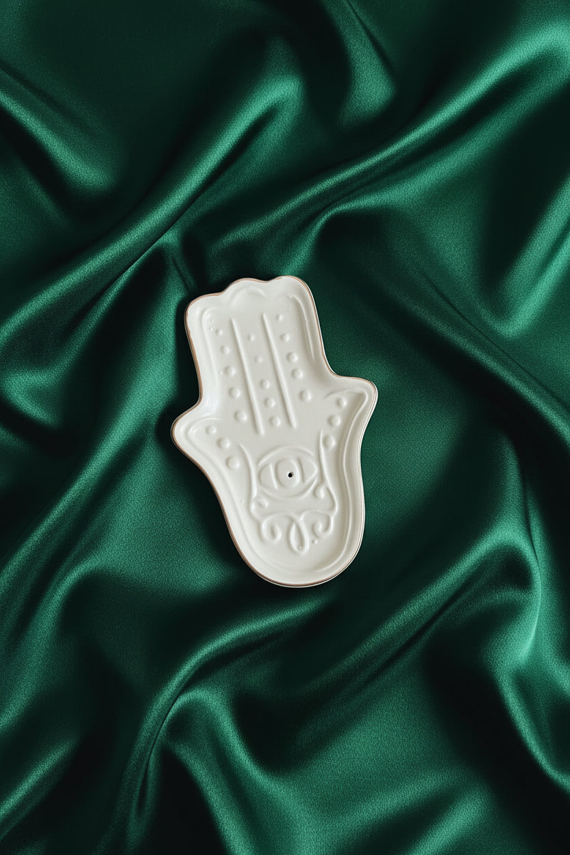 White ceramic dish with decorative patterns on a green surface