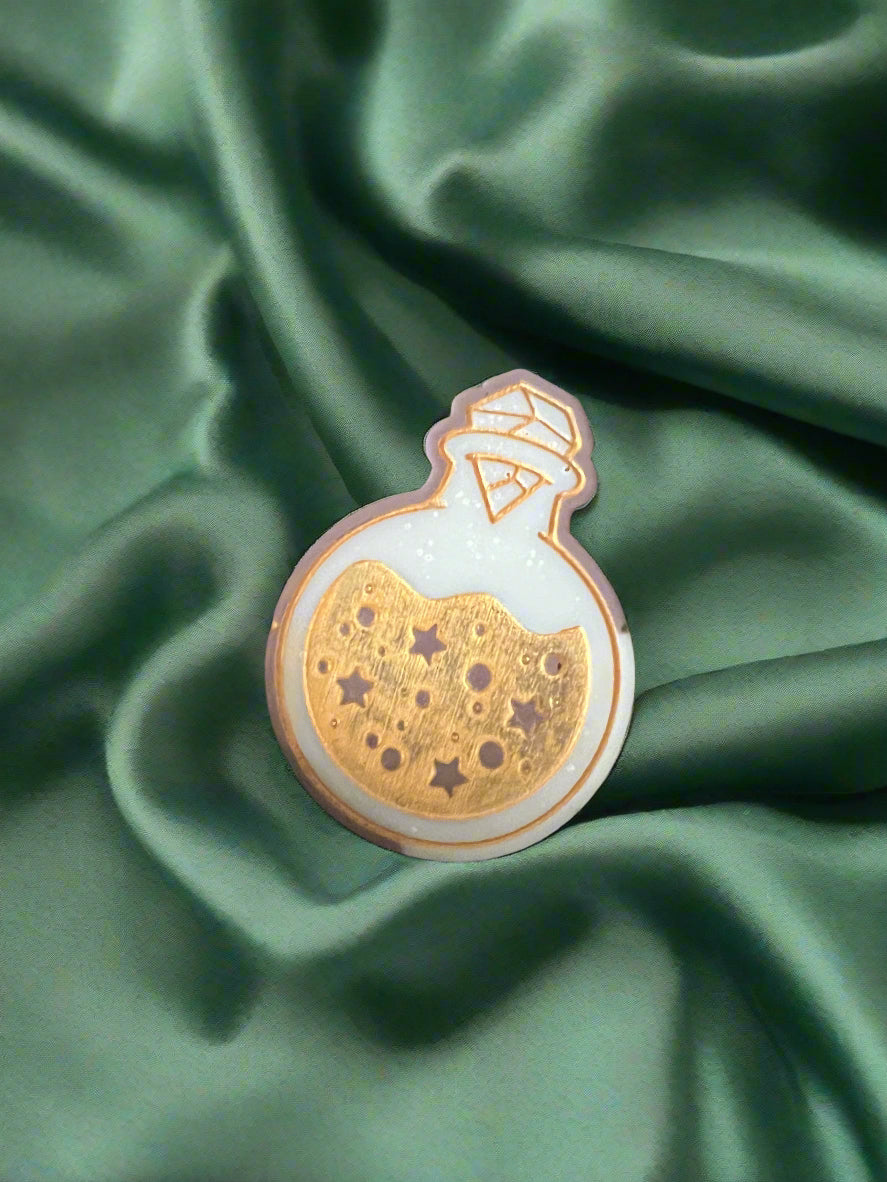 Moon Water wax melt on a dark green satin fabric