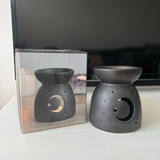 Black ceramic oil burners on a white surface, Moon and Stars