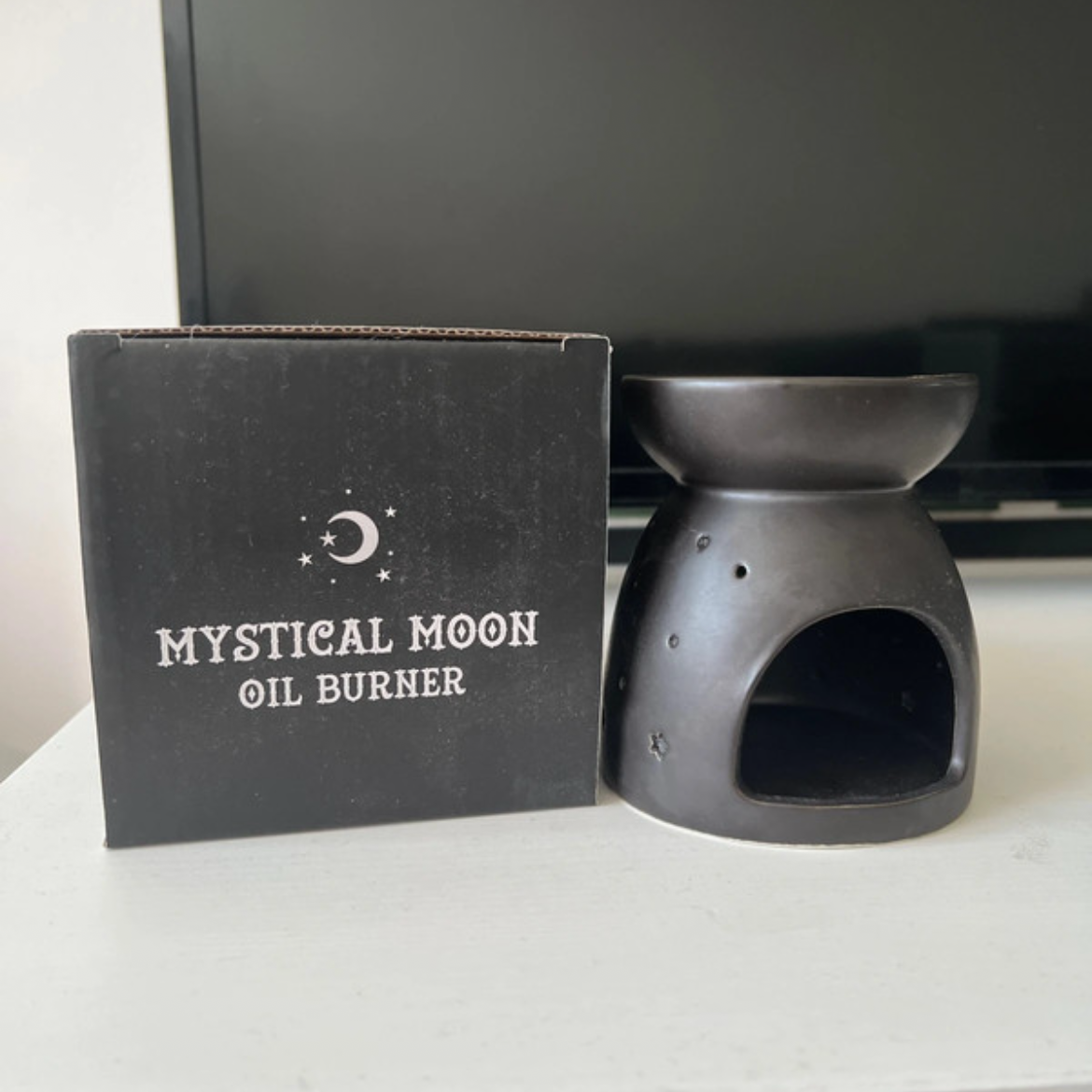 Mystical Moon oil burner with packaging on a white surface