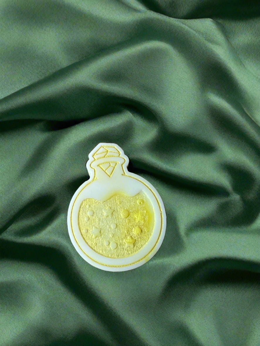 Moon Water wax melt on a dark green satin fabric
