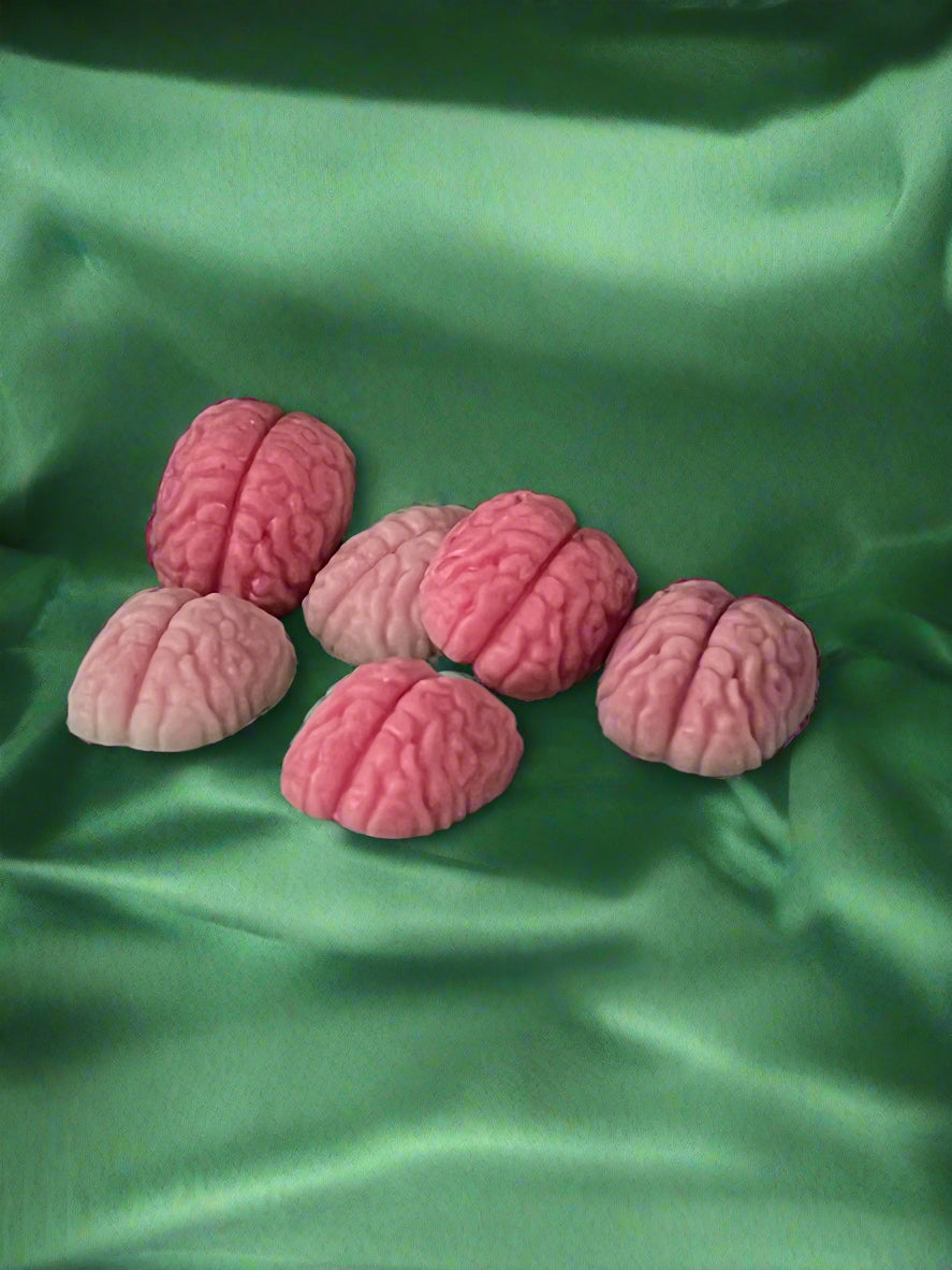 Six brain-shaped wax melts in pink colour, displayed on a dark background
