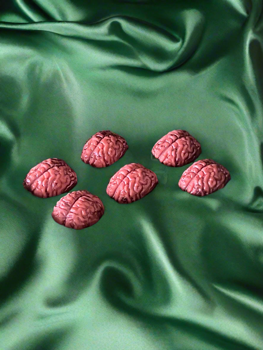 Six brain-shaped wax melts in red, displayed on a dark background
